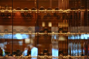 Rows of wine-safe LED lights illuminate the interior of a custom wine storage unit
