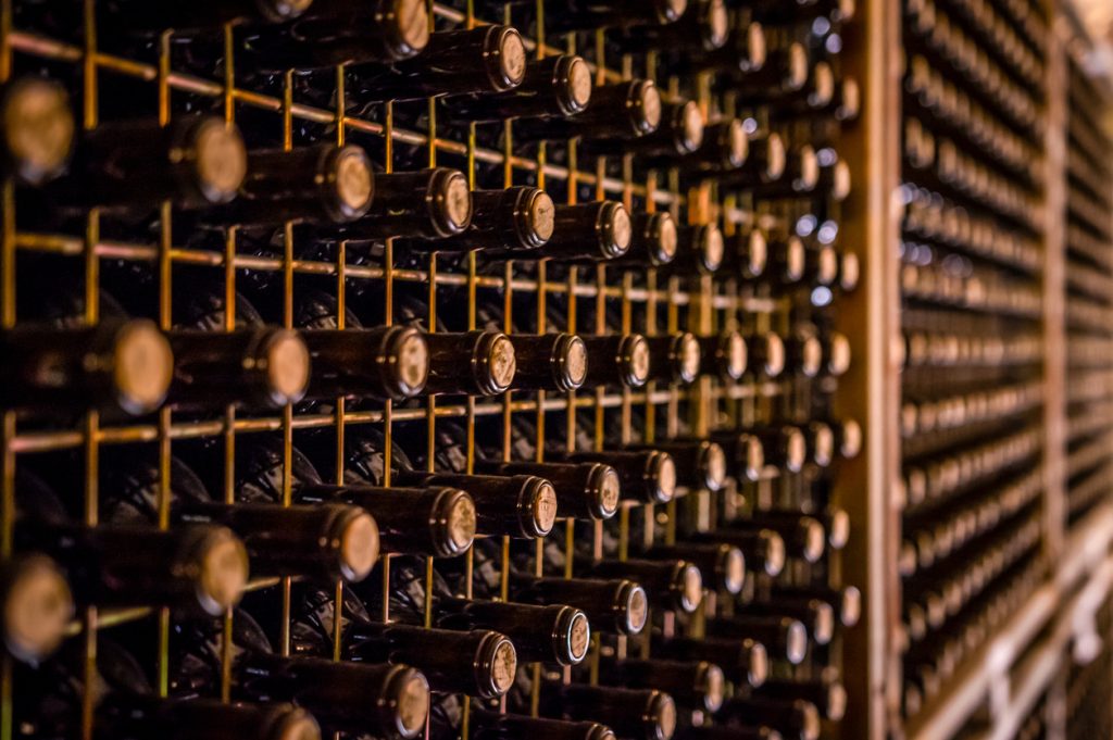 Wine bottles in residential cellar in selective focus